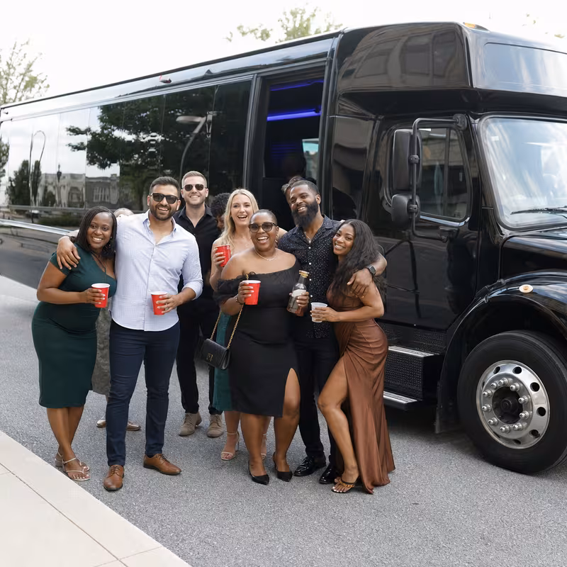 Group boarding a white charter bus for Birthday Transportation transportation in Oakland
