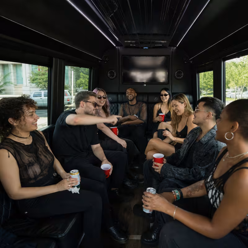 Group boarding a white charter bus for Concert Transportation transportation in Oakland