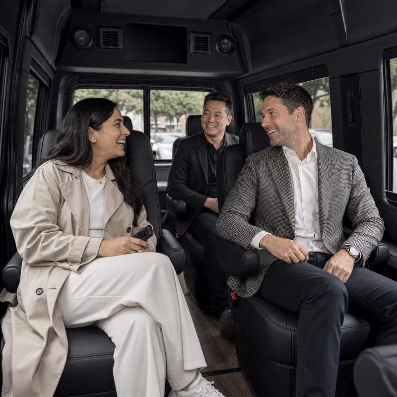 Group boarding a white charter bus for Corporate Transportation transportation in Oakland