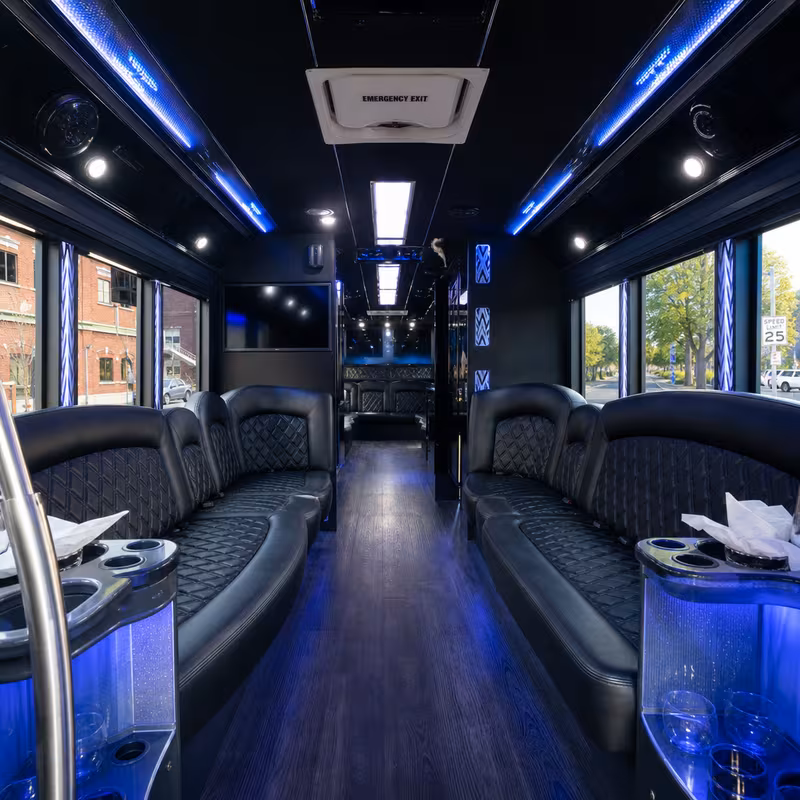 Party bus interior with wraparound leather seating and LED lighting in Oakland