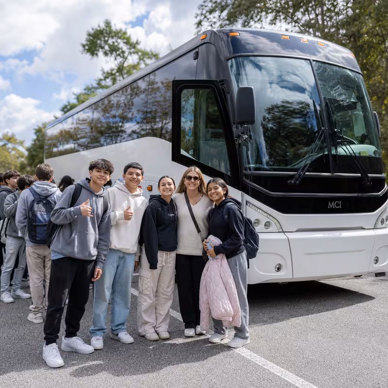 Passengers loading luggage while boarding an Oakland group shuttle