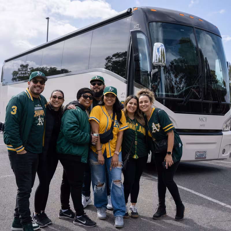 Passengers loading luggage while boarding an Oakland group shuttle