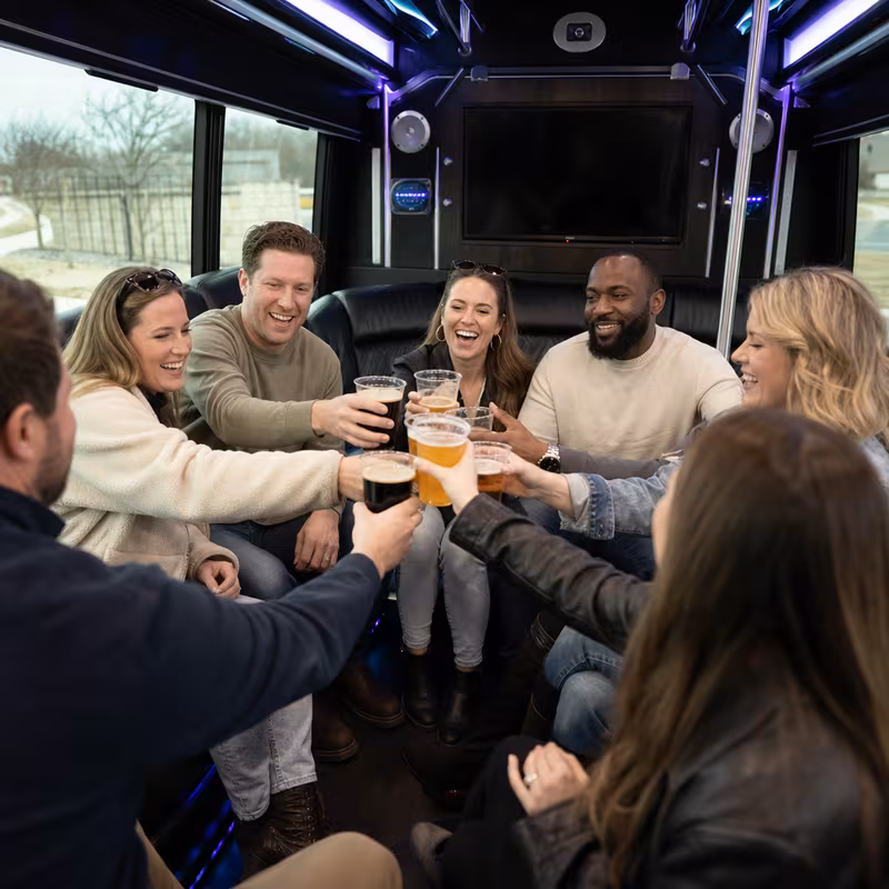 Group boarding a white charter bus for Winery & Brewery Tour Transportation transportation in Oakland