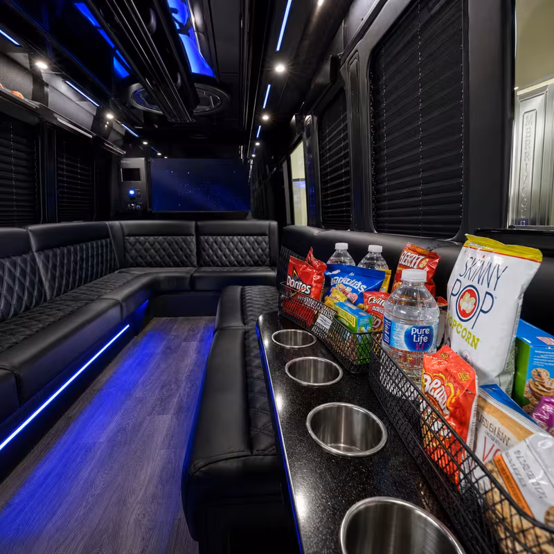 Party bus interior with wraparound leather seating and LED lighting in Oakland